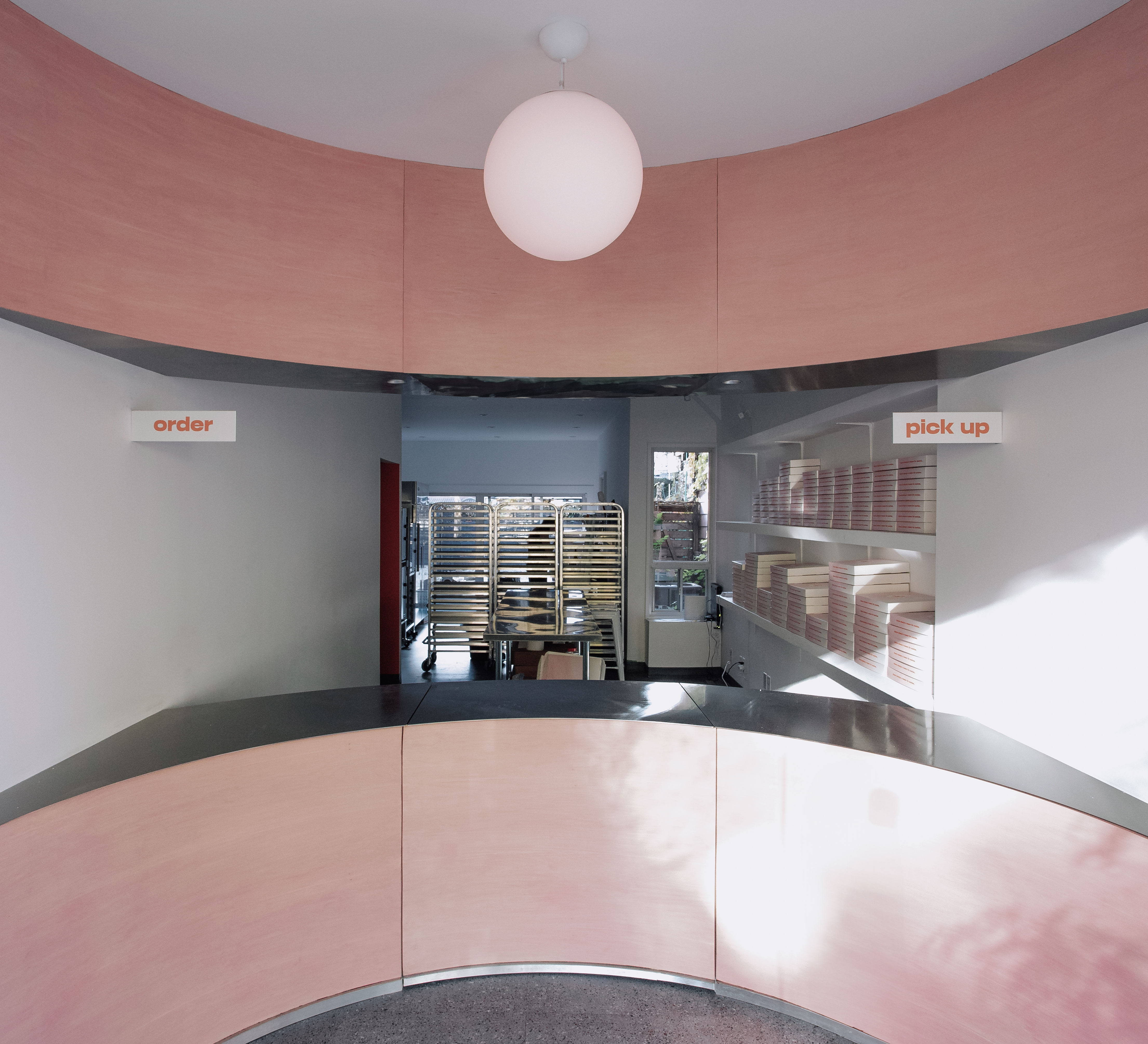 Curved pink interior at Andrea's Cookies, Toronto, by Studio AC