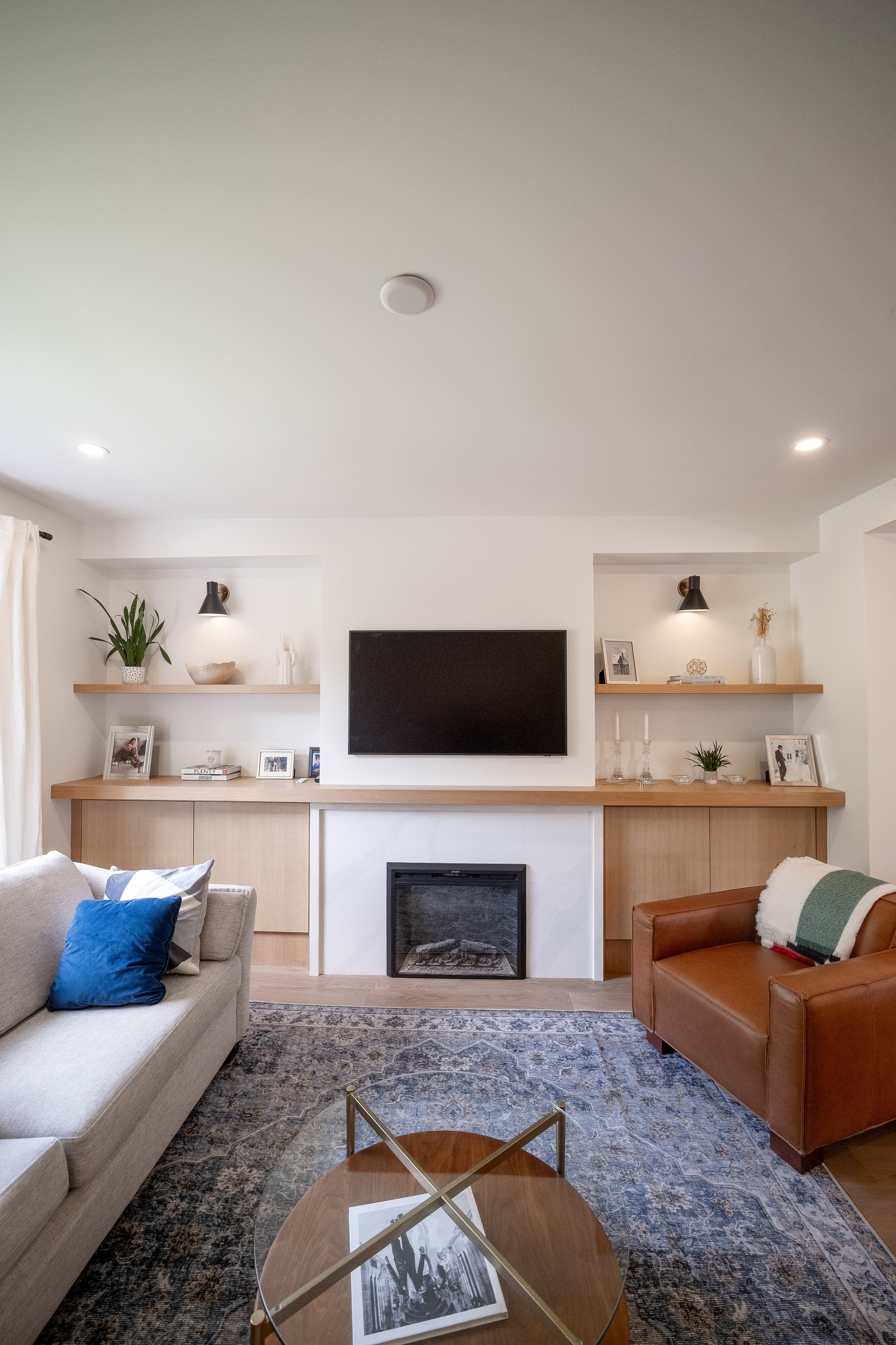Living room with white oak built-ins and fireplace wall, High Park renovation, Toronto, by Doty Construction
